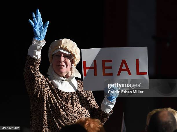 Bettie Robertson of Nevada holds a sign as she waits to see Republican presidential candidate Ben Carson speak during a campaign rally at the...