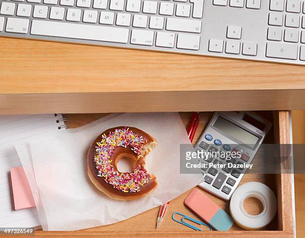 guilty doughnut hidden in desk drawer - drawer bildbanksfoton och bilder