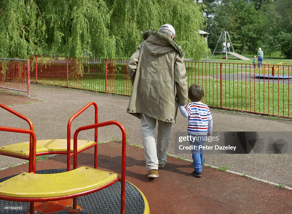 Stranger leading child out of playground