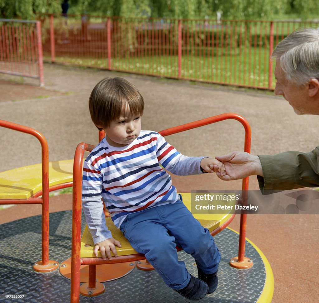 Stranger enticing child off ride in playground
