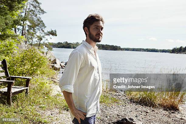 young man looking away, sweden - stockholm beach stock pictures, royalty-free photos & images