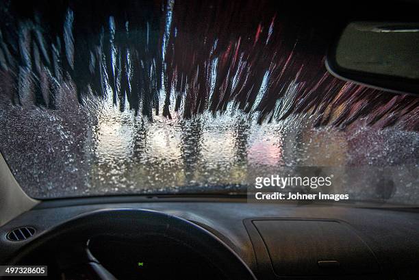 water in carwash splashing on car window, orebro, sweden - car wash ストックフォトと画像