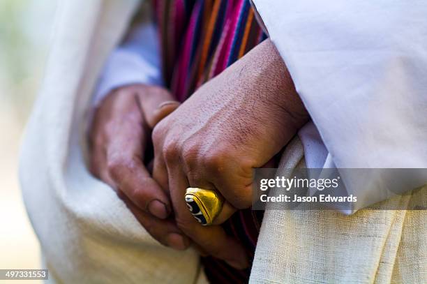 an ornate brass ring on the finger of a buddhist visiting a monastery. - paro dzong stock pictures, royalty-free photos & images