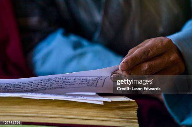 ancient sanskrit text on the parchment of a buddhist monk performing a death ceremony. - ボンゴ ストックフォトと画像