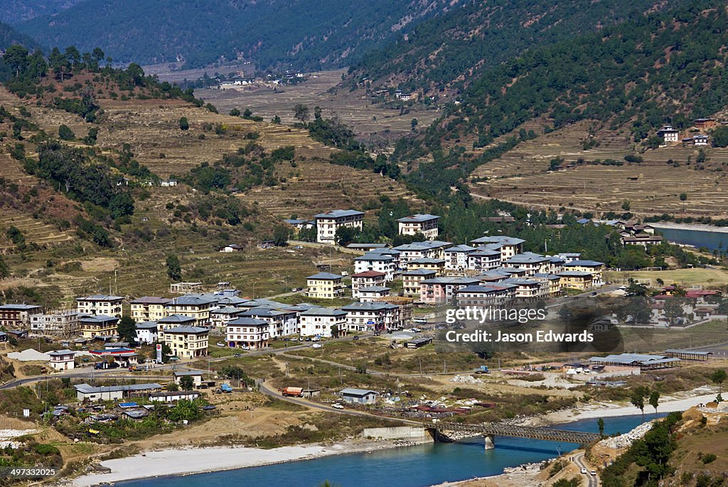 A cluster of Bhutanese homes and apartments in a town on the shores of the Paro River valley.