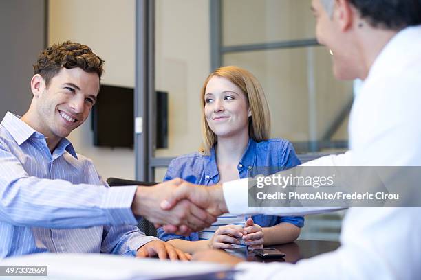 businessman shaking hands with client in meeting - handshaking in a bank stock-fotos und bilder