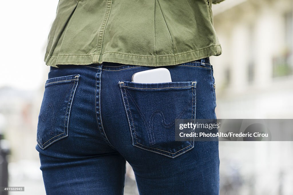 Woman carrying smartphone in back pocket