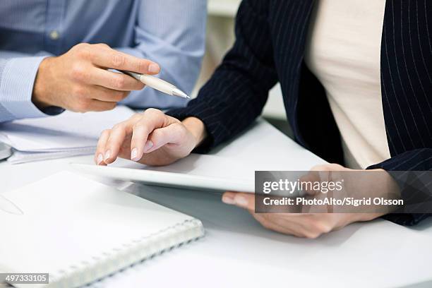 colleagues using digital tablet, cropped - hands explaining stock pictures, royalty-free photos & images