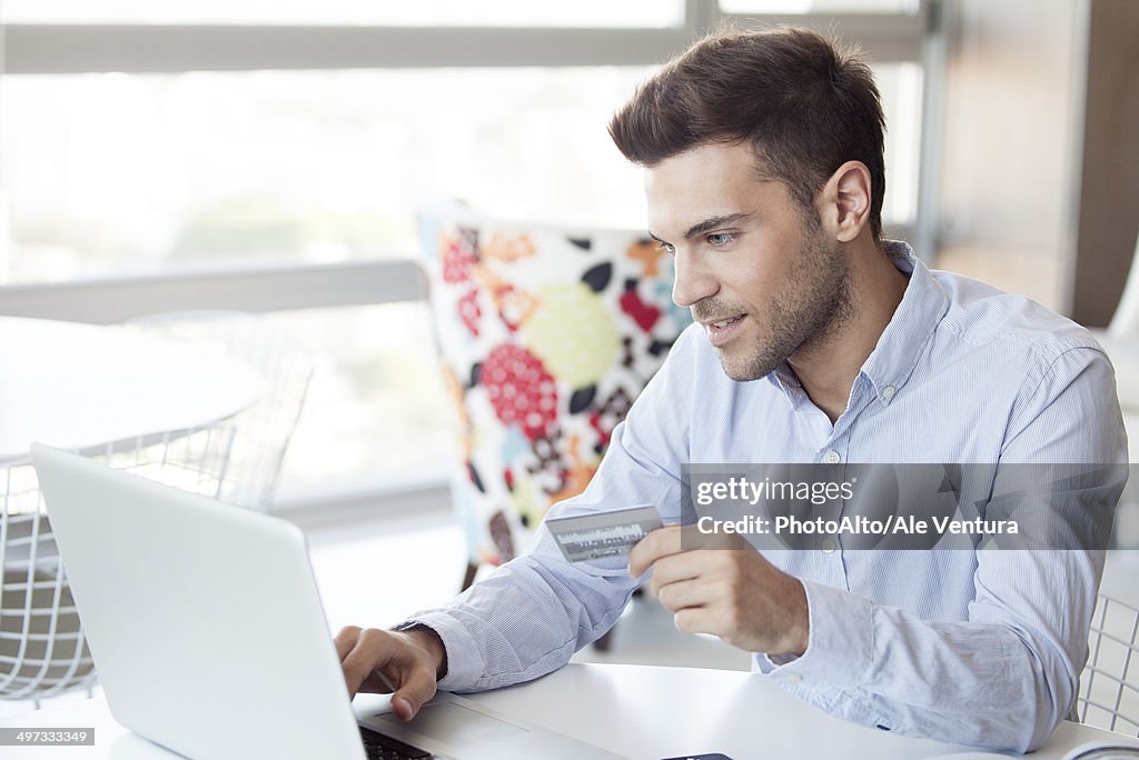 Man preparing to make online purchase using credit card