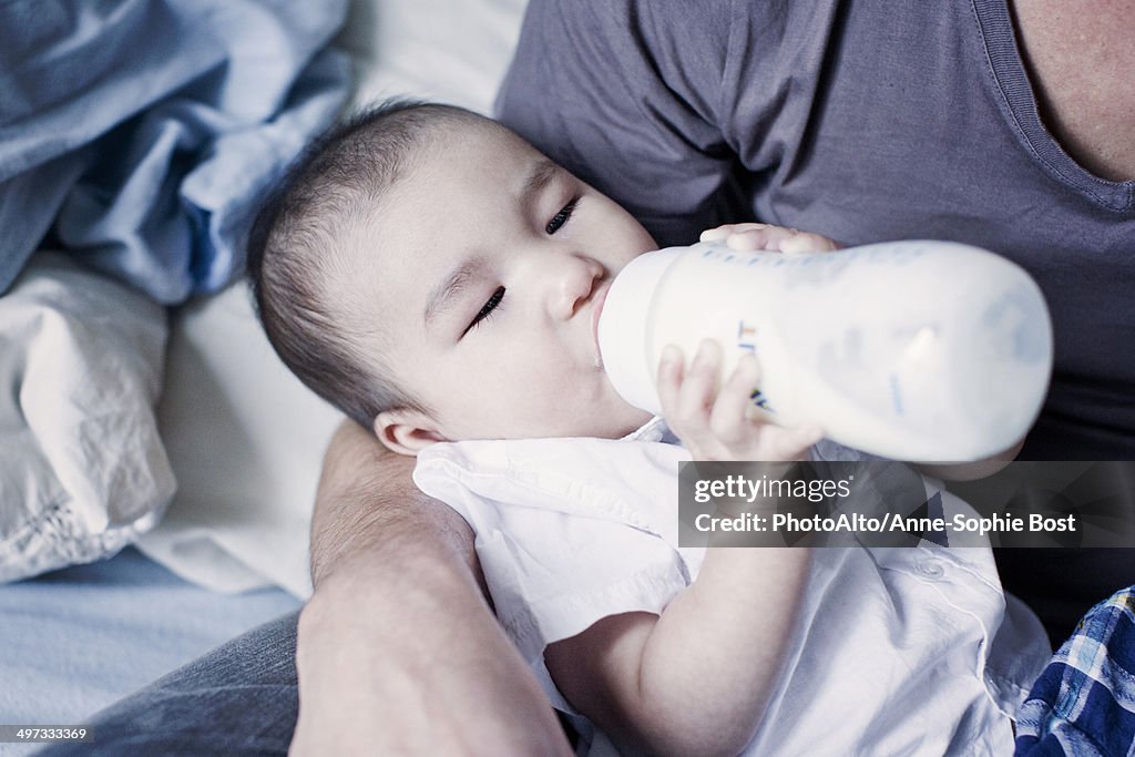 Father feeding bottle feeding baby