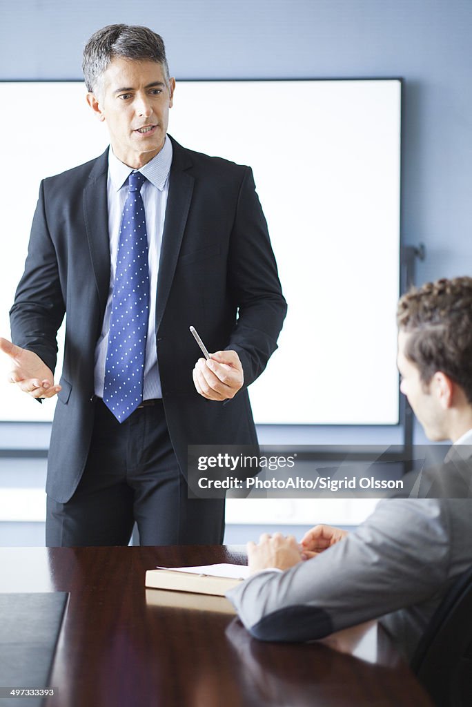 Business executive giving presentation at meeting