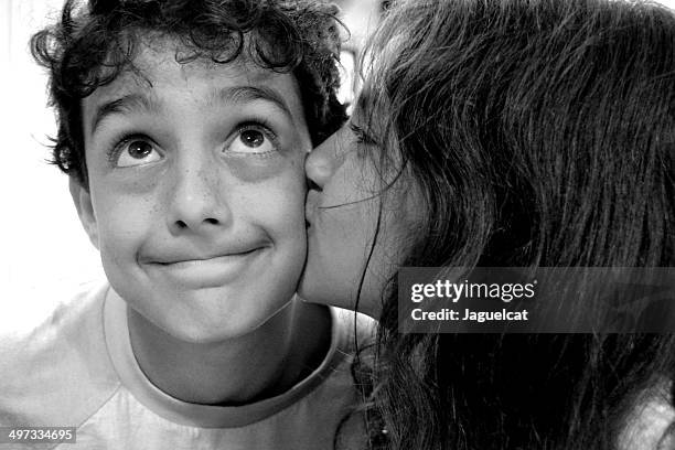 girl kissing boy on the cheek - innocence stock pictures, royalty-free photos & images