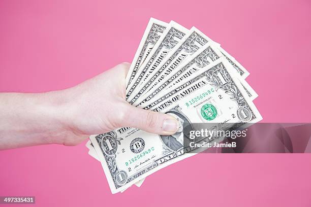 woman's hand holding us banknotes - 5 note stock pictures, royalty-free photos & images