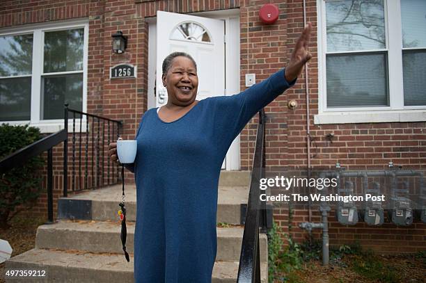 Janet Sharpe waves to a passing neighbor outside of her new home in Washington, D.C. On Nov. 2, 2015. With the help of Open Arms Housing, Inc.women...