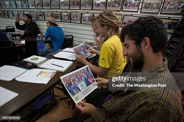 October 28: Oaksterdam student Chris Bergan reacts to his class photo with Aubrey Lewis and Michael Perman after receiving them before their...