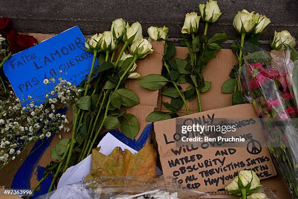 Flowers and messages are left in Trafalgar Square as Londoners gather to observe a minute's silence for the victims of the terrorist attacks in Paris...