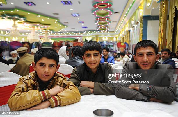 Afghan boys from the Pashtun ethnic group celebrate a wedding inside a cavernous, glittering, segregated wedding hall in Kabul, Afghanistan, on...