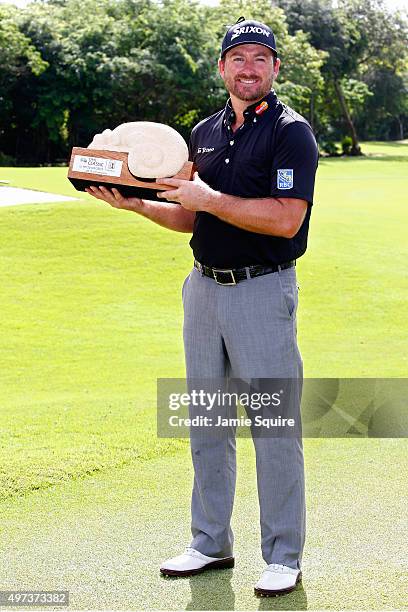 Graeme McDowell of Northern Ireland poses with the trophy after winning the three man playoff in the final round of the OHL Classic at the Mayakoba...