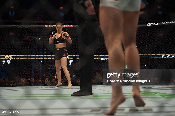 Ronda Rousey stares across the Octagon at Holly Holm in their UFC women's bantamweight championship bout during the UFC 193 event at Etihad Stadium...