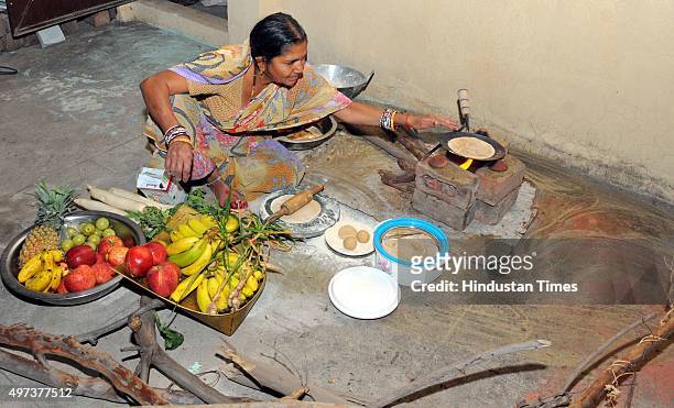 Woman observing fast on the occasion of 'Kharna' - part of the Chhath Puja, is seen preparing dinner which is consumed after the sunset on November...