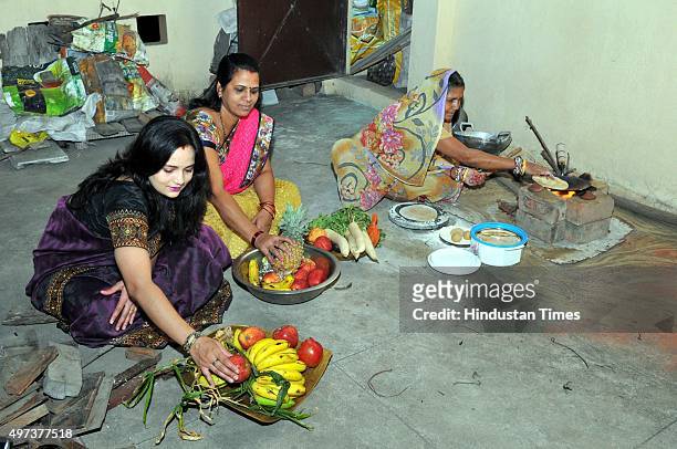 Women observing fast on the occasion of 'Kharna' - part of the Chhath Puja, are seen preparing dinner which is consumed after the sunset on November...