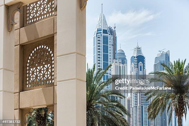 dubai cityscape, new modern skyscrapers and contrasting traditional architecture - dubai palm stock pictures, royalty-free photos & images