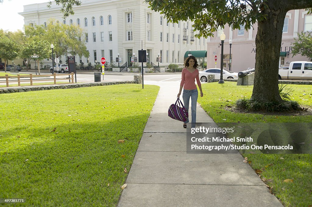 Young Brunette Female Walking in a Park