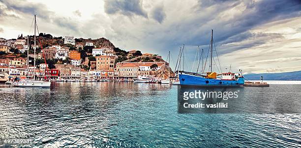 panorama of the port of hydra, greece, under moody sky - hydra greece fotos stockfoto's en -beelden