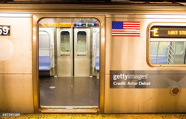 new york city subway open train with usa flag - new york city subway stock-fotos und bilder