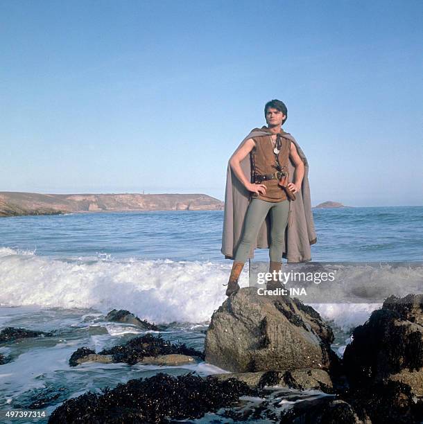 Outdoor on a beach of rocks, Jean Claude Drouot in the person of Thierry La Fronde on the shooting of the fourth series of the famous serial