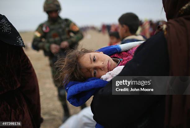 Civilians flee from their ISIL or Daesh-held frontline village to a Kurdish-controlled area on November 16, 2015 to Sinjar, Iraq. Peshmerga forces...