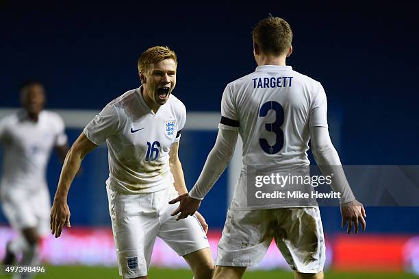 Duncan Watmore of England celebrates with team mate Matt Targett after scoring during a European Under 21 Qualifier between England U21 and...