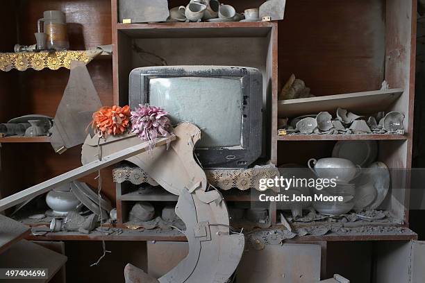 Household goods stand covered in dust in the rubble of a home destroyed by an airstrike on November 16, 2015 in Sinjar, Iraq. Kurdish forces, with...