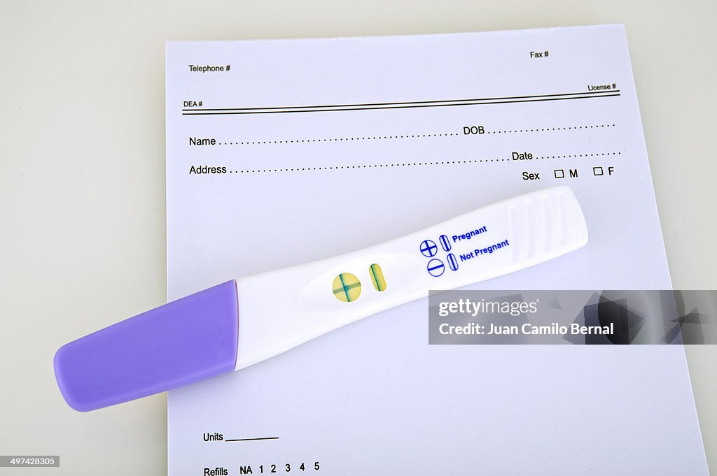 Pregnancy test over prescription booklet