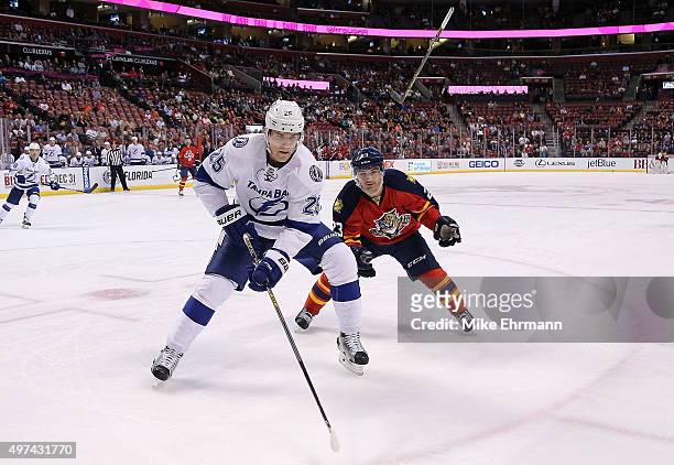 Matt Carle of the Tampa Bay Lightning and Rocco Grimaldi of the Florida Panthers fight for the puck during a game at BB&T Center on November 16, 2015...