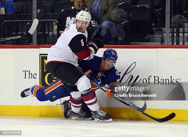 Connor Murphy of the Arizona Coyotes checks Brock Nelson of the New York Islanders during the first period at the Barclays Center on November 16,...