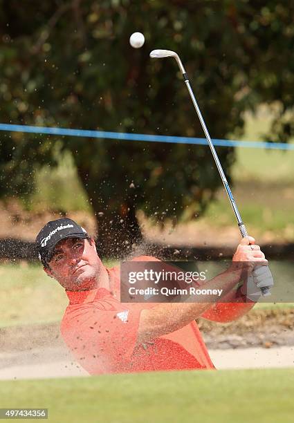 Steven Bowditch of Australia plays out of the bunker during a practice round ahead of the 2015 Australian Masters at Huntingdale Golf Course on...