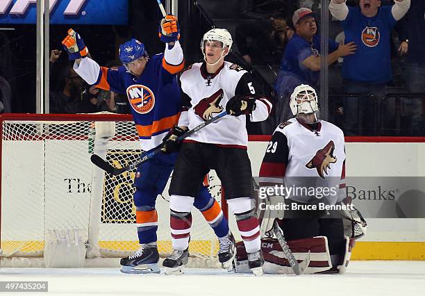 Steve Bernier of the New York Islanders celebrates his third period goal against Anders Lindback of the Arizona Coyotes as Connor Murphy looks on at...