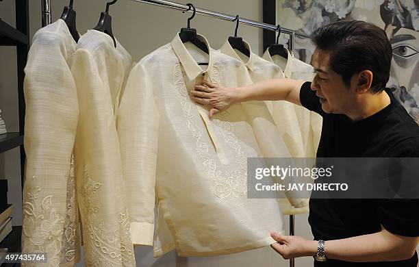 This photo taken on November 12, 2015 shows Filipino designer Paul Cabral explaining how he designed the "barong" or formal shirts that Asia-Pacific...