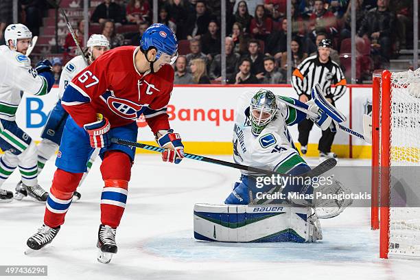 Max Pacioretty of the Montreal Canadiens gets the puck past goaltender Jacob Markstrom of the Vancouver Canucks and scores during the NHL game at the...