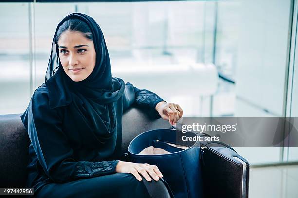 beautiful emirati woman at lounge - arab home stock pictures, royalty-free photos & images