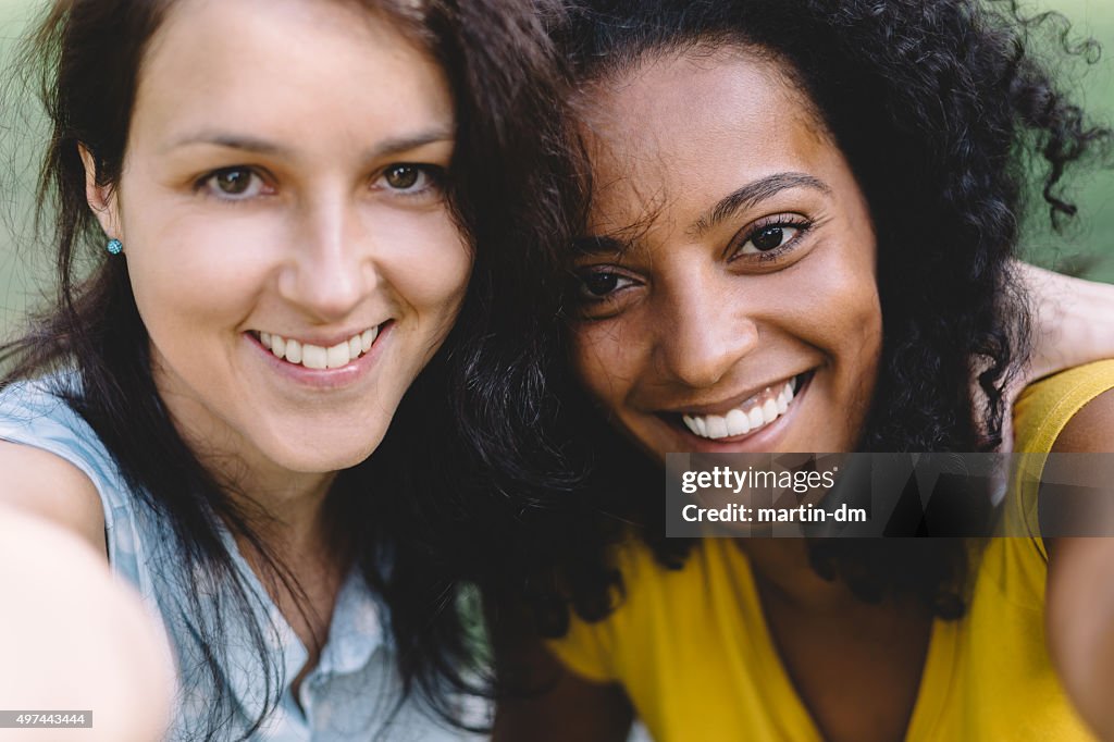Happy girls taking a selfie together