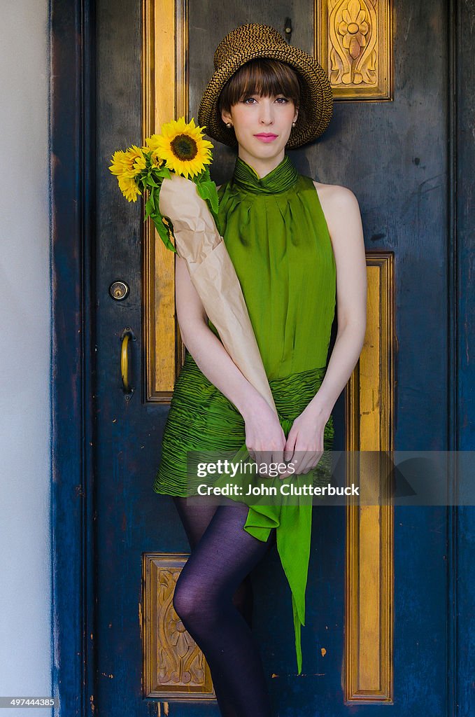 Girl in green dress with sunflowers