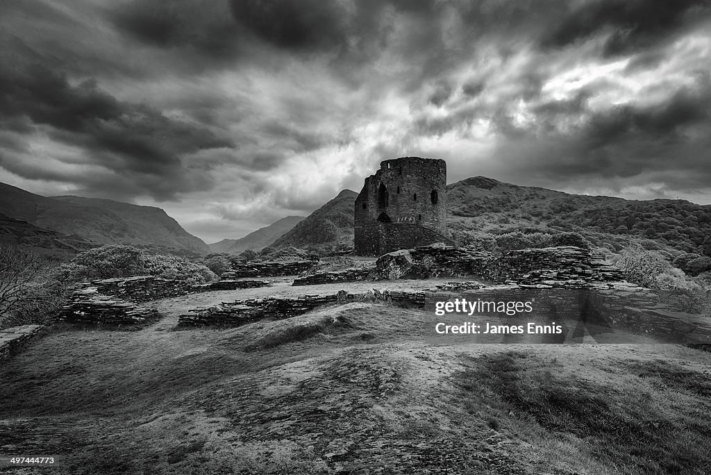 Castle ruins, monochrome with mountain backdrop