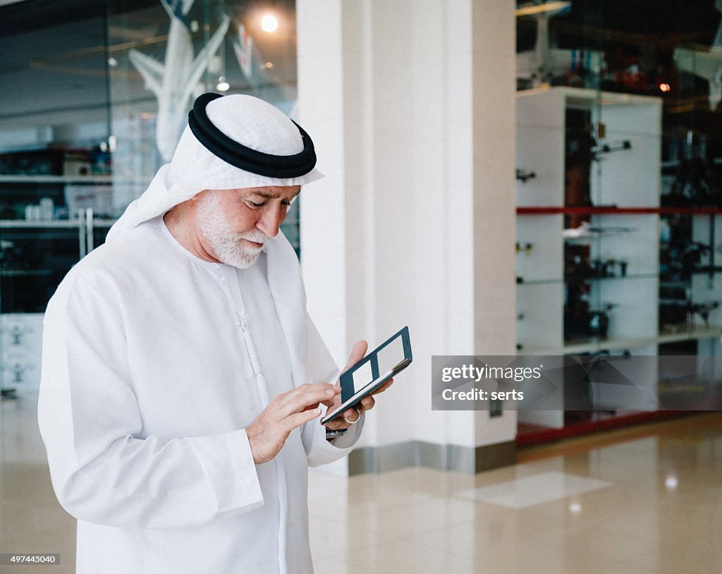 Senior Arabian Man with cellphone