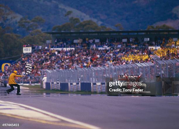 Alain Prost of France, in the Marlboro McLaren International McLaren MP4/2C TAG V8 turbo, takes the chequered flag to win the Australian Grand Prix...