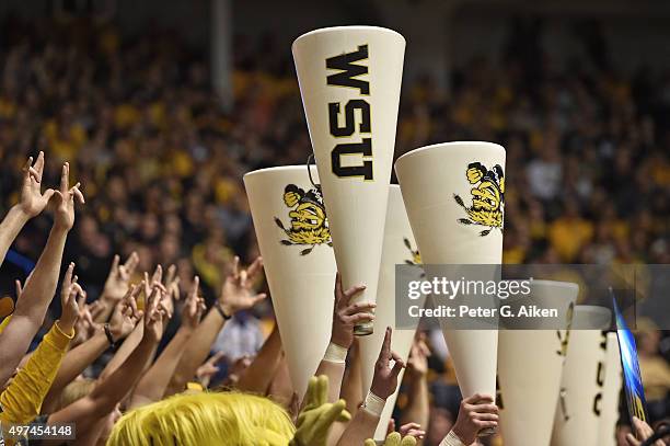 Shocker fans cheer and hold up megaphones during a game between the Wichita State Shockers and the Charleston Southern Buccaneers during the first...