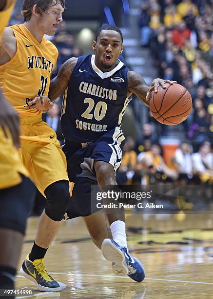 Guard Demetrius Pollard of the Charleston Southern Buccaneers brings the ball up field against guard Ron Baker of the Wichita State Shockers during...