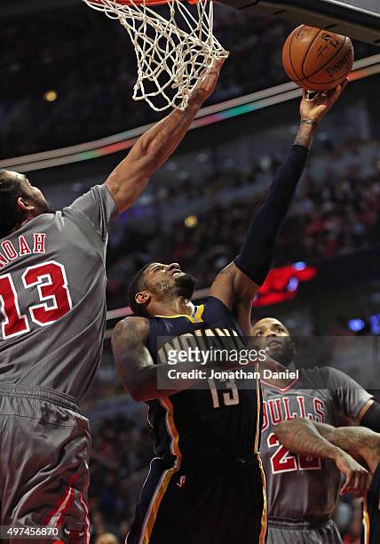 Paul George of the Indiana Pacers puts up a shot between Pau Gasol and Taj Gibson of the Chicago Bulls on his way to a game-high 26 points at the...