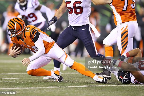 Andy Dalton of the Cincinnati Bengals is tackled by Christian Covington of the Houston Texans during the second quarter at Paul Brown Stadium on...